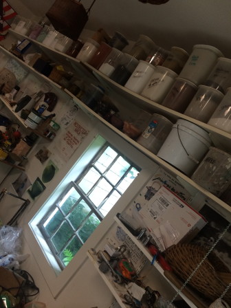 The "ingredients" of George McEvoy's glazes in containers on shelves in his home pottery studio. Credit: Michael Dinan