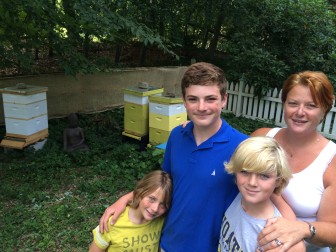 L-R: Sumner, Liam, Caleb and Michelle Orr stand near the family's beehives in New Canaan. Credit: Michael Dinan