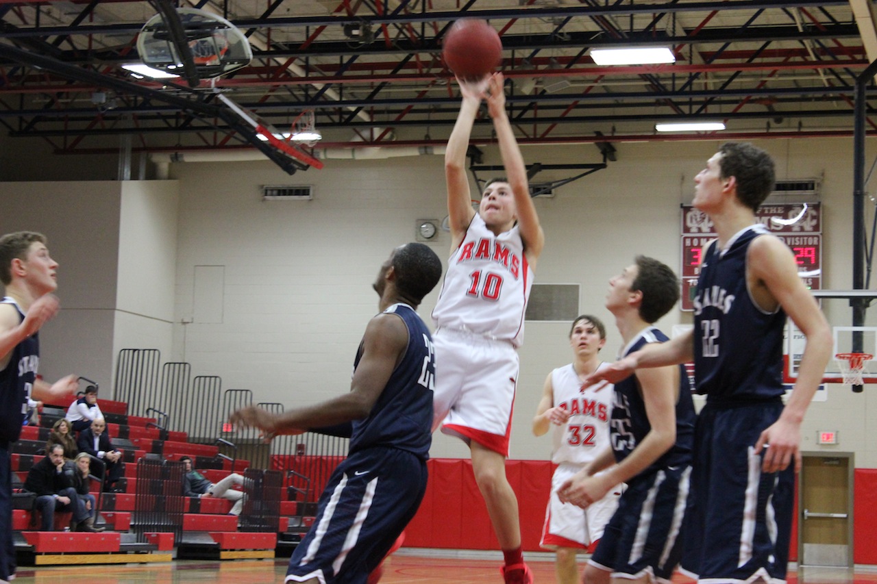 New Canaan's Tyler Sweeney hits a jump shot as the Rams top Staples 46-40. (Terry Dinan photo)