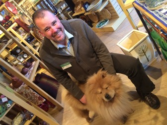 Shawn Webb and his Chow Chow, Arusha, at their place of work, Ten Thousand Villages. Credit: Michael Dinan