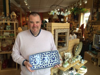 Shawn Webb, store manager at Ten Thousand Villages' New Canaan location, holds a handcrafted Vietnam serving platter created by a female artisan. These types of items represent the majority of gifts available in the shop, Webb said. Credit: Michael Dinan