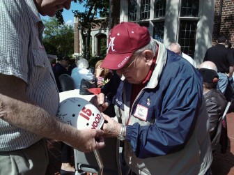 Ray signing a helmet for the 1960 state champions, when they were honored by the New Canaan Old Timers in 2010. Contributed photo