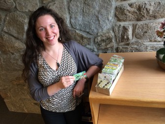 Melanie Kelly holds a packet of seeds in the area where New Canaan Library plans this month to install a "seed library" for residents.