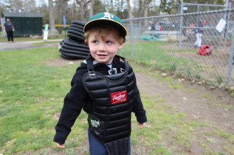 Three year-old Kieran Rogers wearing big brother Danny's catcher's gear.