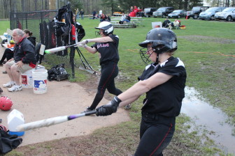 Rachel and Molly Keshin take some practice cuts as they await their turn at the plate.