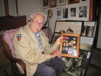 New Canaan icon Syd Greenberg with some of his medals. Credit: Terry Dinan
