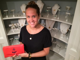 Virginia Utley is manager at She la la—she's holding one of the New Canaan shop's handbags, a favorite item of the staff at Island Outfitters nearby. Credit: Michael Dinan