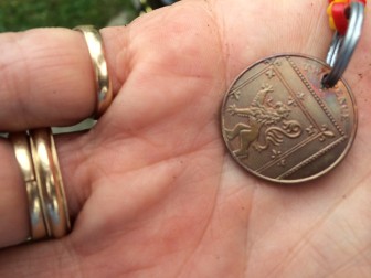 Killeffer acquired this two-pence (“tuppence”) coin in England in 2011 and brought it home. Soon, her Cocker Spaniel named Zoe developed terminal kidney disease and she lost the dog. She named the next pet ‘Tuppence,’ and keeps the lucky coin on a sort of keychain she made herself. Credit: Michael Dinan