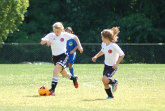 Caroline Underwood (L) and Ellie Gallois (R) move the ball up the field on a scoring drive for New Canaan Soccer Girls U10 Red Soccer Team. Contributed photo