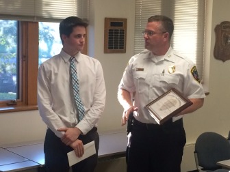 Grayson Cordes, left, receives a Civilian Service Award from New Canaan Police Chief Leon Krolikowski on Sept. 18, 2014. Cordes' alertness and quick action led to the arrest in July of three out-of-state residents arrested for conspiracy to commit sixth-degree larceny. Credit: Michael Dinan