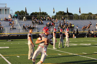New Canaan QB Mike Collins warms up. (Terry Dinan photo)