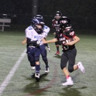 Holden Busby picks up big yards for New Canaan. (Jen Gentner photo)