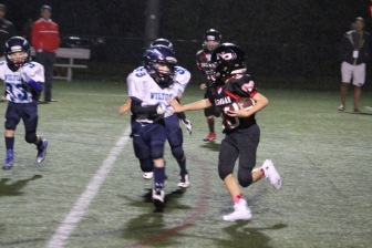 Holden Busby picks up big yards for New Canaan. (Jen Gentner photo)