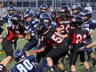 Dominic Rasso (#77) and Eoin Mueller (#51) apply the big hit as Jeremiah Brayboy (#24) and Brendan Hagan (#22) assist in the pileup. (Jen Gentner photo)