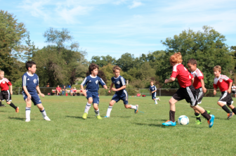 New Canaan U9 Red players from right to left: Teddy Werner, Jaden Oyekanmi and Will Langford maneuver past Westport players to get the ball to Ethan Schubert for a goal. Contributed photo