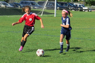 New Canaan U11 Girls Red team's Kaleigh Harden dribbles past her Wilton opponent. Contributed photo