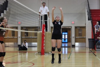 New Canaan senior Gracie Castle with a set in volleyball action this season. Credit: Terry Dinan