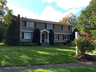 This 1958 Colonial on Village Drive sits on .39 acres and includes 3,496 square feet of living space. It sold in October 2014 for $1.5 million. Credit: Michael Dinan