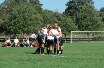 New Canaan's U11 Girls Red huddle up before the opening whistle in a show of solidarity. Contributed photo