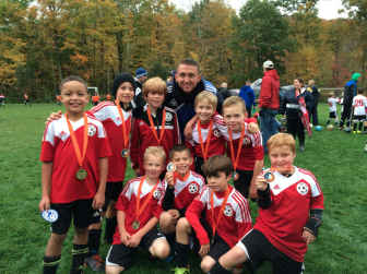 NC U9 Boys Red Soccer team shows off their medals after Saturday's Columbus Day tournament in Ridgefield.  Back row Jaden Oyekanmi, Ted Werner, Will Langford, Coach Chris Gilligan, Ethan Schubert, Ben Bilden.  Front row: Max Lowe, Teddy Balkind, Connor Lytle, Teddy Hoffstein.