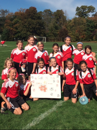 New Canaan's U11 Girls Red soccer team celebrates their CT Cup semi-final victory against Ridgefield on Saturday. Contributed photo