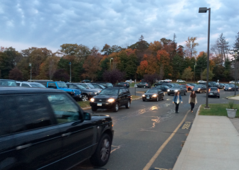Students crossing the main access road at the New Canaan High School parking lot on the morning of Oc.t 28, 2014. Credit: Michael Dinan
