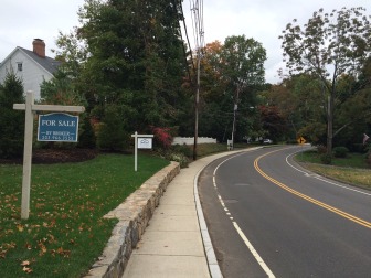 The second sign here on Main Street near Woodland Road, from a contractor, appears to be in direct violation of the Zoning Regulations of the town. Enforcement officers are taking a look at the area for violations. Credit: Michael Dinan