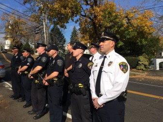 New Canaan Police Department members who have served stand by during a Veterans Day ceremony at God's Acre on Nov. 11, 2014. Lt. Jason Ferraro in the foreground. Find a full list here: http://bit.ly/1szTsnx Credit: Michael Dinan