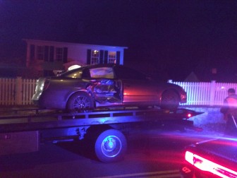 A motor vehicle involved in the 2-car accident on the evening of Nov. 13 is towed from Main Street at Woodland Road. Credit: Michael Dinan