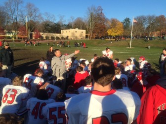 New Canaan Football head coach Lou Marinelli addresses his players after Saturday's 47-16 win at Trinity Catholic. The team now ramps up for an FCIAC final vs. rival Darien at the Turkey Bowl, and the CIAC state tournament. Credit: Michael Dinan