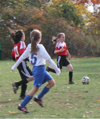 Kelly Polacek and Kailee See beat Norwalk's defense in New Canaan's win on Sunday. Contributed photo