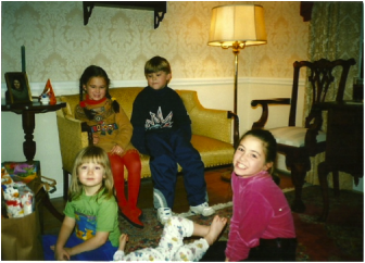 A picture of me and my cousins at our grandparent’s house in the late 90’s during the annual family get-together of opening gifts.  From left to right are Rachel Barber, Hailey Sauerhoff and her older sister, Emily Sauerhoff. Courtesy of Jes Sauerhoff 