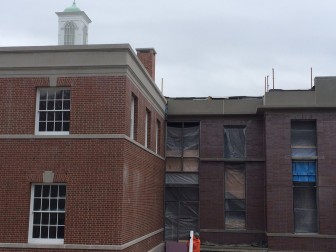 The precast concrete bands that run along the top of the original Town Hall and between its floors are continued in the new addition. Other features, notably the style of brick and windows, are more modern. This photo from Jan. 14, 2015. Credit: Michael Dinan