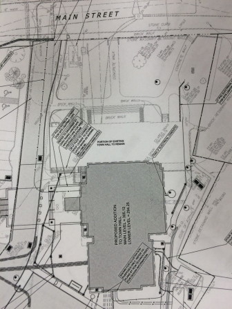 The sidewalk is depicted here by the dots interspersed by lines, running alongside the Town Hall driveway. The addition is the darkened section here and the original structure is the wide white portion above it.