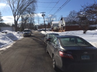 Cars often are parked on both sides of East Maple Street, making it impassable to two-way traffic, one resident of the street says. Credit: Michael Dinan