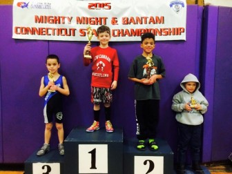 New Canaan's Brady Kaupp, a 7-year-old South School student, stands atop the podium for his first-place finish in the 45-pound weight class at this month's CT State Wrestling Championships. Contributed