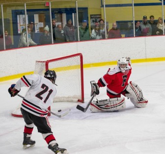 Parker Lewis (#21) scores the game-winner as New Canaan defeats Fairfield, February 28, 2015. Credit: Stacy Mettler