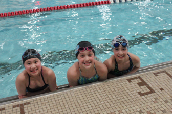 Members of the Age Group State Champion Caimans 10/Under Girls relay team (left to right): Elisabeth Xia, Julia Cassone, Kaylana Couture (Hutton Saunders not pictured)