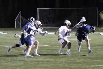 New Canaan's Frank Cognetta with lock-down defense as the Rams defeated Wilton 14-3 on Thursday, April 23, 2015. Credit: Terry Dinan