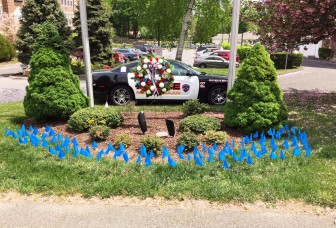 For National Police Week, the New Canaan Police Department is honoring 127 officers who lost their lives in the line of duty with this memorial outside headquarters. Each blue flag represents one life. Photo Courtesy of the New Canaan Police Department