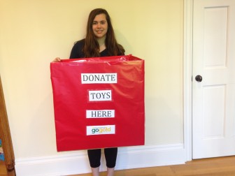 New Canaan High School junior Kaylee Paladino with a donation box for her Girl Scout gold project. 