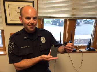 New Canaan Police Officer Ron Bentley holds up the FirstVu-brand body camera. Soon all NCPD officers on patrol will be using the devices, Police Chief Leon Krolikowski said. Credit: Michael Dinan