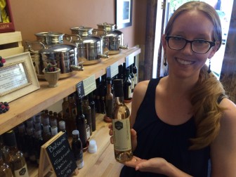 New Canaan Olive Oil owner Heidi Burrows with the Elm Street shop's hugely popular champagne-infused balsamic vinegar. Credit: Michael Dinan