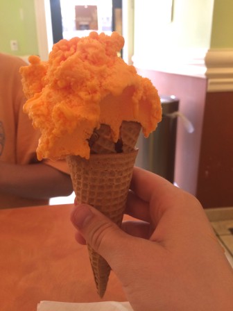 A scoop of Fresh Orange gelato in a sugar cone. Photo by Mackenzie Lewis.