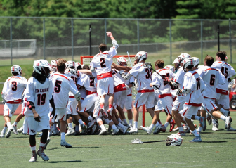 The New Canaan Rams boys lacrosse team earned a Class M state title with a 10-5 win over the Daniel Hand Tigers. Credit: Chris Cody