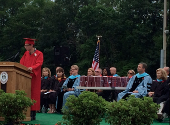 Class of 2015 senior Sean Davidson speaks during "Moments of Reflection" at New Canaan High School graduation on June 18, 2015. Credit: Michael Dinan