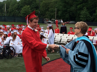 Senior Alex Hutchins receives his diploma from NCHS Principal Roni LeDuc at New Canaan High School graduation on June 18, 2015. Credit: Michael Dinan