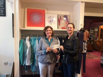 Owner L’Armoire Diane Roth giving the check to AFH Founder and Clinical Director Karen Nisenson. Contributed