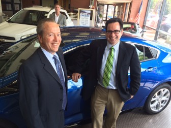 Karl Chevrolet President Leo Karl III and Connecticut Department of Energy and Environmental Protection Commissioner Robert Klee stand near a 2016-model Chevy Volt, an electric vehicle, during a discussion of the new 'CHEAPR' rebate program offered by the state, on July 29, 2015. Credit: Michael Dinan