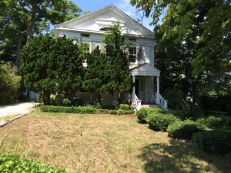 Historic District officials are concerned about the future of a long vacant Greek Revival-style home at 4 Main St. on God's Acre. Recently, one commissioner arranged to have the grass cut. Credit: Michael Dinan